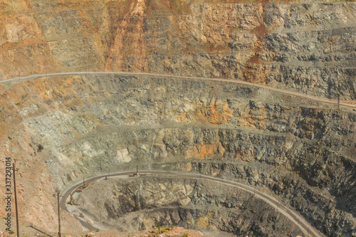 Daily general view of the quarry for mining iron ore. In sunny weather. It is visible special equipment used for mining minerals and iron ore.