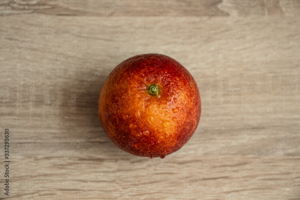 juicy red orange on a wooden table closeup, exotic fruit juicy red orange on a wooden table closeup, exotic fruit
