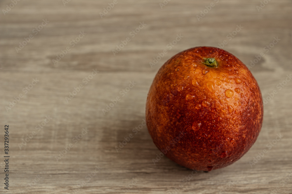 juicy red orange on a wooden table closeup, exotic fruit juicy red orange on a wooden table closeup, exotic fruit