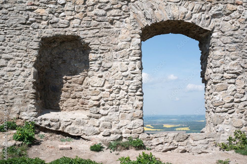 Window, alcove and hole in wall of antique building made of stone. Detail of fortress, ruin and remains from medieval age.