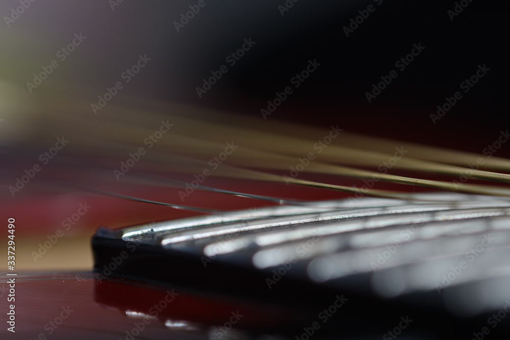 Fototapeta premium Abstract background in strings of an acoustic guitar macro