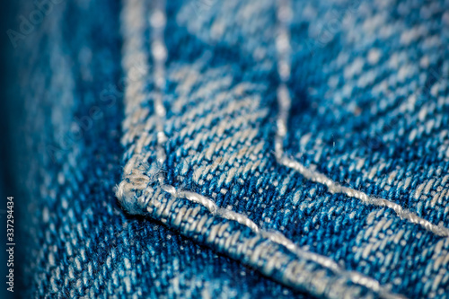 Close up of a blue jeans pocket's seam