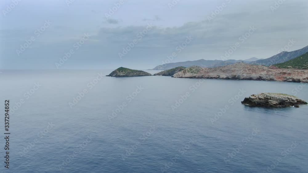 Aerial shot flying over sea on the coast of Crete Island. Dolly in Aerial shot flying over sea on the coast of Crete Island. Dolly in