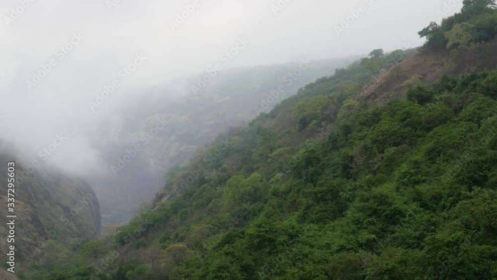 Timelapse of the mist entering a green valley in the western ghats of India and the sunlight passing through it Timelapse of the mist entering a green valley in the western ghats of India and the sunlight passing through it
