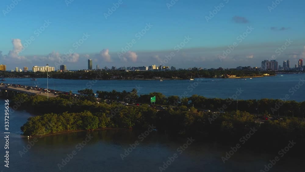 Aerial Miami Beach bay and city skyline, storm clouds on the horizon, crystal blue water, slow pan right and up Aerial Miami Beach bay and city skyline, storm clouds on the horizon, crystal blue water, slow pan right and up