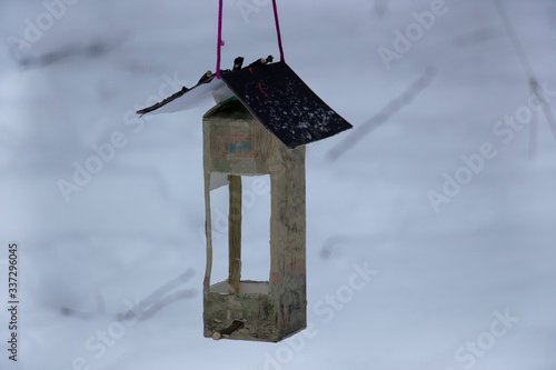 Birdhouse on a tree in a snowy forest