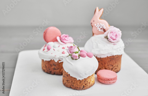 Easter orthodox sweet bread, Easter cake with flowers and gingerbread. Holidays breakfast concept with copy space. Easter greeting card template. Homemade pasques.Easter sweets on grey background.