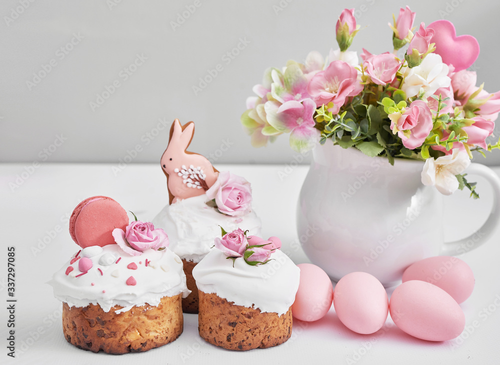 Easter sweet bread, Easter cake with flowers, eggs and gingerbread. Holidays breakfast concept with copy space. Easter greeting card template. Homemade pasques.Easter sweets on white background. Easter sweet bread, Easter cake with flowers, eggs and gingerbread. Holidays breakfast concept with copy space. Easter greeting card template. Homemade pasques.Easter sweets on white background.