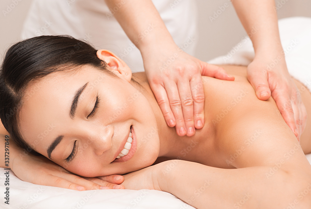 Thai Massage therapy. Portrait asian woman enjoying back massage at the spa.