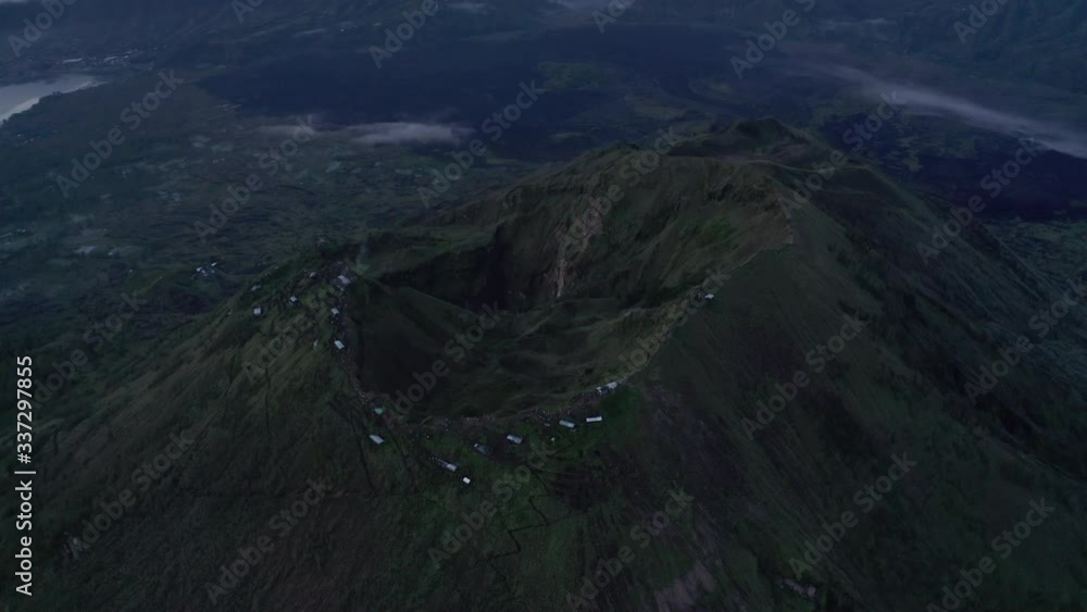Open shot of Batur volcano crater in the early morning with reveal of great caldera in the background, Bali, Indonesia. Open shot of Batur volcano crater in the early morning with reveal of great caldera in the background, Bali, Indonesia.