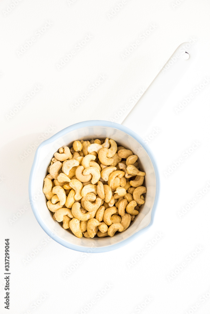 Raw Cashews in White Enamel Pot Raw Cashews in White Enamel Pot