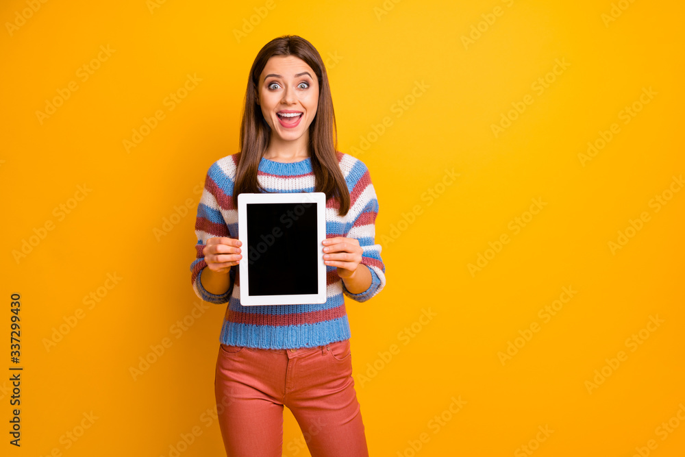 Portrait of her she nice attractive amazed stunned cheerful cheery brown-haired girl holding in hands showing new ebook isolated over bright vivid shine vibrant yellow color background Portrait of her she nice attractive amazed stunned cheerful cheery brown-haired girl holding in hands showing new ebook isolated over bright vivid shine vibrant yellow color background