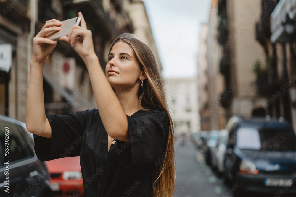 Girl takes photo on her phone to memorize the moment of her travel. Women use their gadgets to communicate in social networks, take pictures, watch videos and share their lives with friends. Girl takes photo on her phone to memorize the moment of her travel. Women use their gadgets to communicate in social networks, take pictures, watch videos and share their lives with friends.