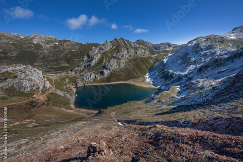 Saliencia lakes in the Somiedo Nature Park, Asturias, Spain. Top view of the Lago de la Cueva at the end of winter, snowy areas in the mountains. photo
