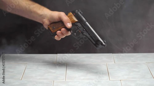 Purchasing Handgun with Stack of Money Across Countertop in Smokey Room photo