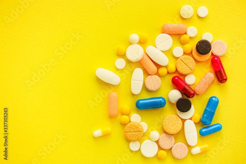 pills, different pills and drugs to treat and increase immunity, medical preparations. background top view. copy space for text