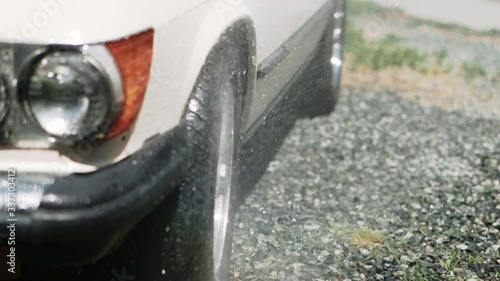 Spraying a wheel of a car with water on a sunny summer day in Canada photo