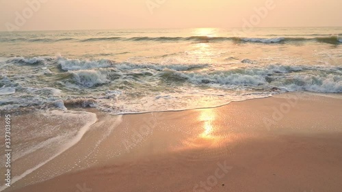Soothing waves of Hua Hin beach Thailand at sunset in slow motion  photo