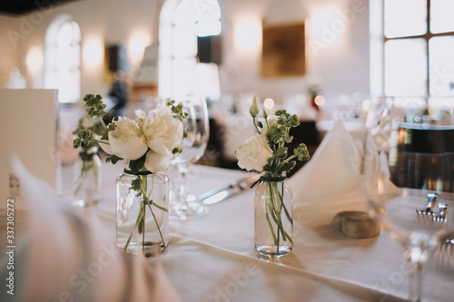 wedding decoration on tables with pharmacy glasses and candles