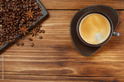 Coffee cup and coffee beans on a wooden background. Top view .