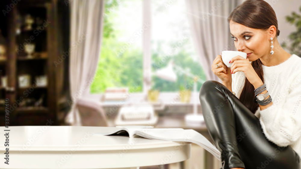 Slim young woman with cup of coffee or tea and white wooden table in home interior with window Slim young woman with cup of coffee or tea and white wooden table in home interior with window