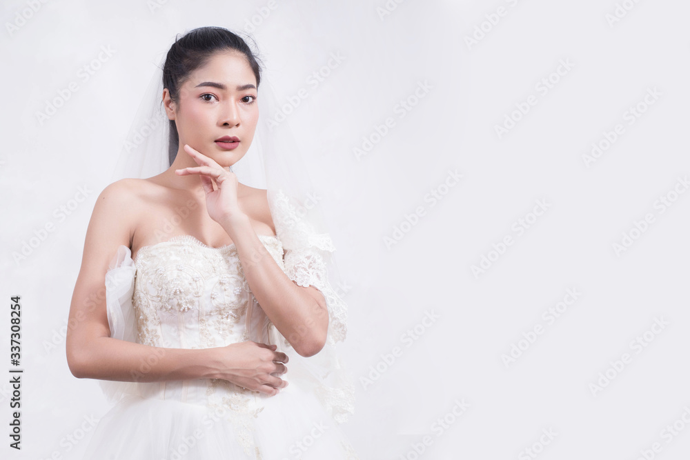 Asian woman is wearing wedding dress with free space on white background Asian woman is wearing wedding dress with free space on white background
