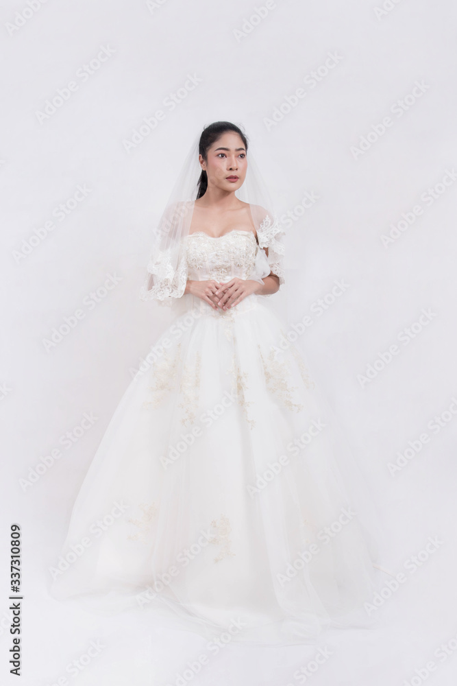 Asian woman is wearing wedding dress with free space on white background Asian woman is wearing wedding dress with free space on white background
