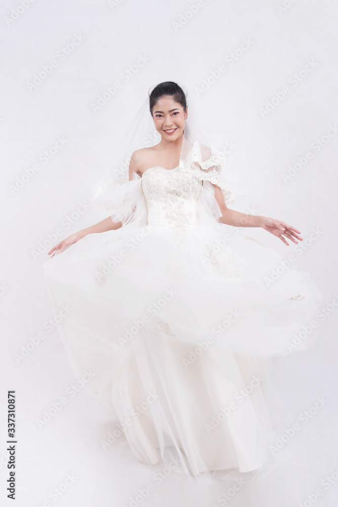 Asian woman is wearing wedding dress with free space on white background Asian woman is wearing wedding dress with free space on white background
