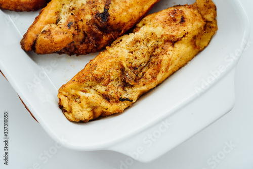 Torrijas, typical Spanish sweet fried toasts of sliced bread soaked in eggs and milk on tray isolated on white background