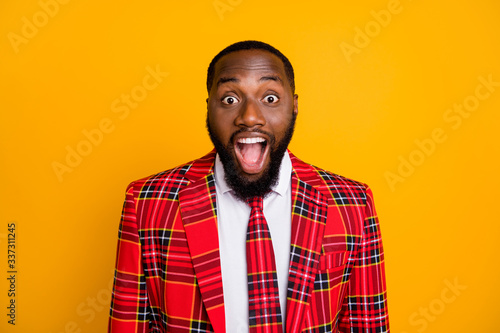 Closeup photo of amazed ecstatic dark skin guy good mood open mouth listen great news wear plaid red costume blazer white shirt isolated bright yellow color background