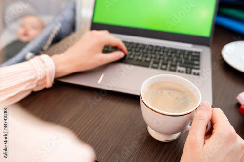 Woman hands typing laptop computer with blank screen for mock up template background, business technology and lifestyle background concept. She is drinking coffee.