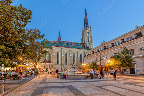 Novi Sad, Serbia - July 19, 2019: Catholic Cathedral The Name of Mary Church and Katolicka Porta square in Novi Sad in the centre of Novi Sad - back yard. The most beautiful fountain in Novi Sad.