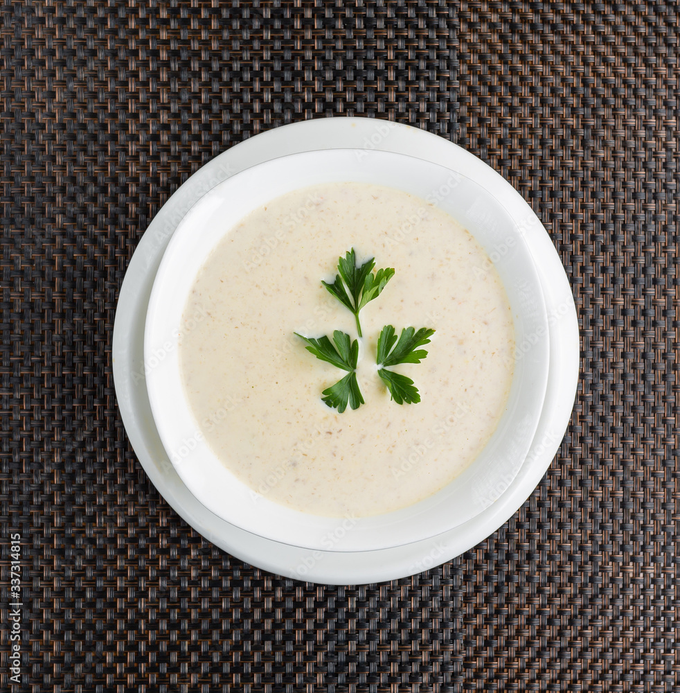 mushroom cream soup with cream in a white bowl mushroom cream soup with cream in a white bowl