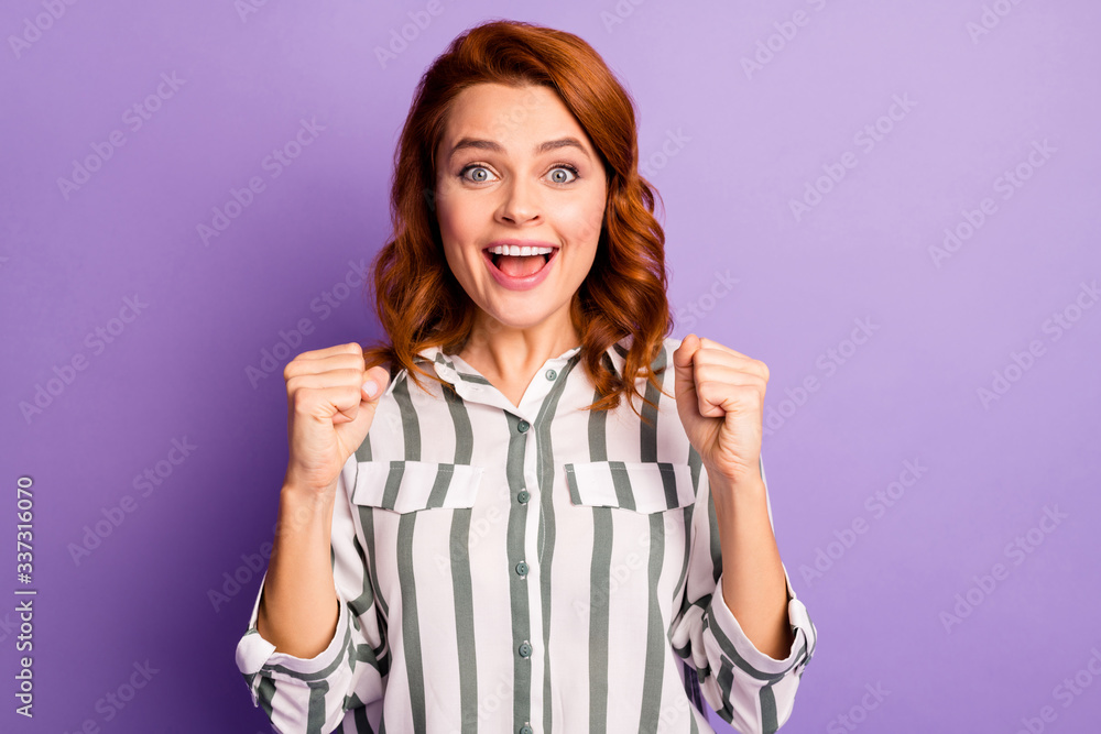 Portrait of funny finky woman win lottery impressed raise fists scream yeah wear stylish clothing isolated over purple color background Portrait of funny finky woman win lottery impressed raise fists scream yeah wear stylish clothing isolated over purple color background
