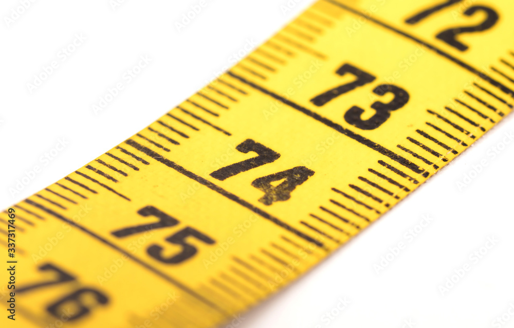Close-up of a yellow measuring tape isolated on white - 74 Close-up of a yellow measuring tape isolated on white - 74