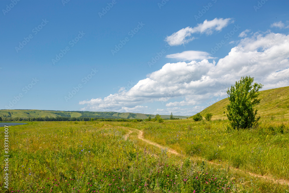 country road in the meadow, valley between the hills country road in the meadow, valley between the hills