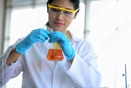 Scientists are working in science labs.Close-up of a scientistYoung female scientist looking through a microscope in a laboratory doing research, microbiological analysis, medicine. photo