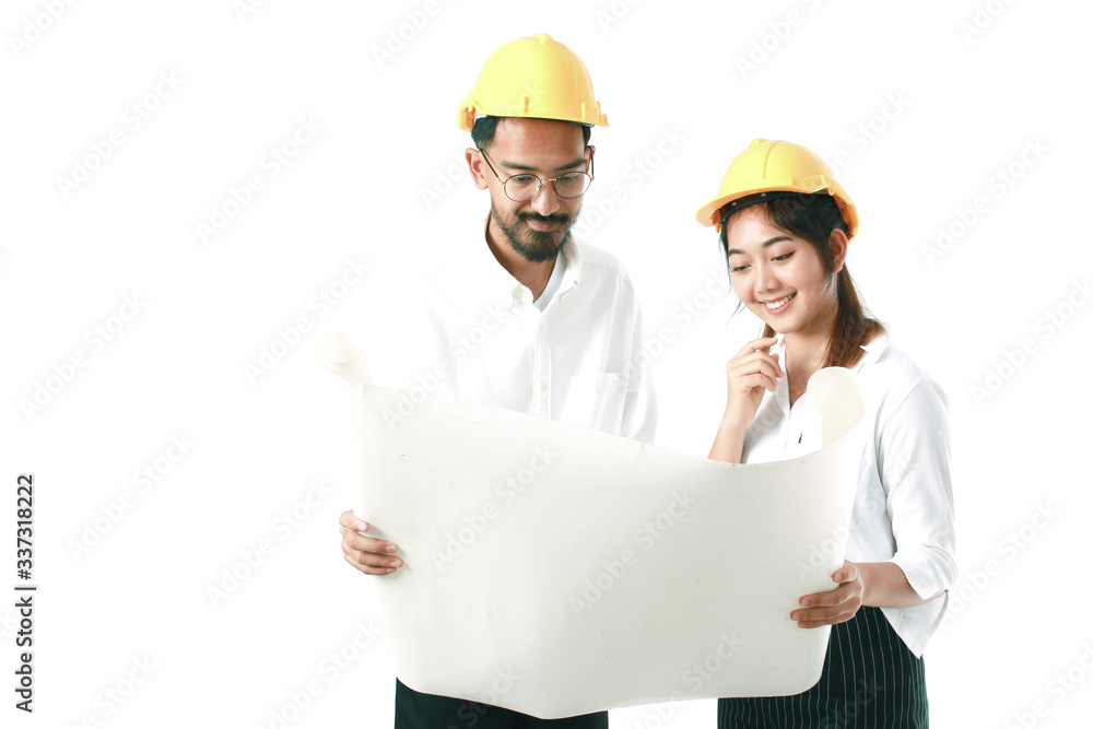 Two engineers wearing safety helmets and discussing about work with copy space isolated on white background. Man with mustaches holding blueprint, smiling pretty Asian woman thinking about project. Two engineers wearing safety helmets and discussing about work with copy space isolated on white background. Man with mustaches holding blueprint, smiling pretty Asian woman thinking about project.