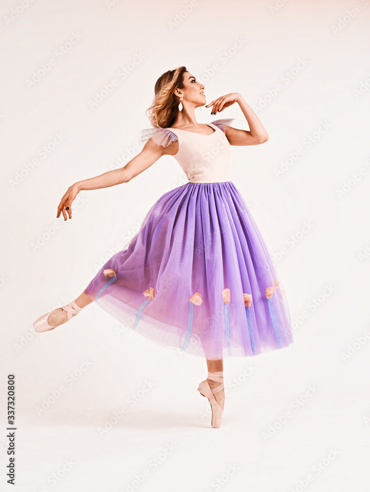 Naklejka premium Ballet dancer or classic ballerina dancing isolated on white studio background. Woman with the violet cloth. The dance, grace, artist, contemporary, movement, action and motion concept
