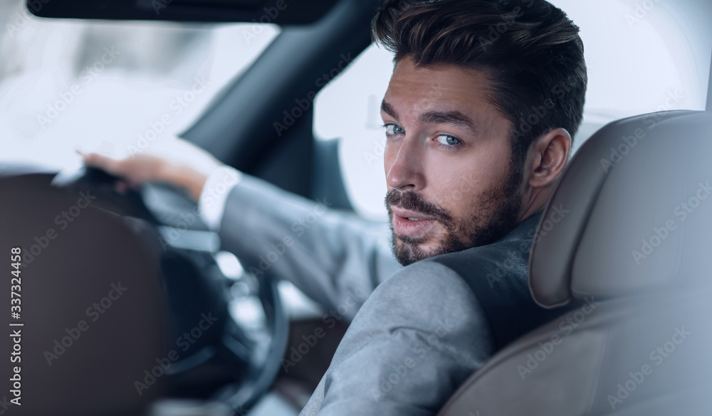 Successful man sitting behind the wheel of a prestigious car Successful man sitting behind the wheel of a prestigious car