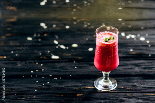 A row of healthy fresh fruit smoothies with mint on dark backgrounds