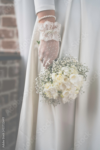 wedding bouquet with white roses in bride's hands