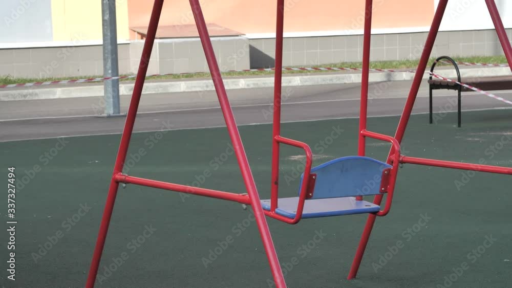 Empty children's playground are closed from children during the quarantine period. Kids playground are covered with protective tape fluctuates in the wind. Russia to combat covid-19 or coronavirus. Empty children's playground are closed from children during the quarantine period. Kids playground are covered with protective tape fluctuates in the wind. Russia to combat covid-19 or coronavirus.