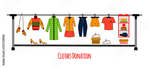 Clothes donation. Charity. Big hanger with different elements as sweater, down jacket, hat, mittens, trousers, shoes, dress, shorts, t-shirt, sneakers.