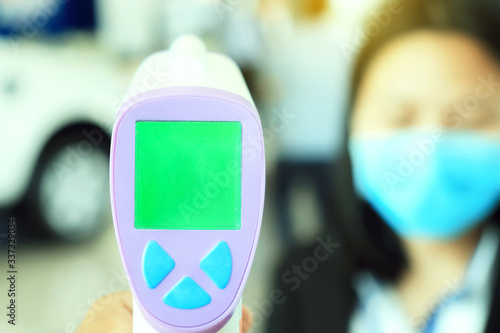 Asian female patient checking how high fever she is using thermometer.Virus spread, health care concept