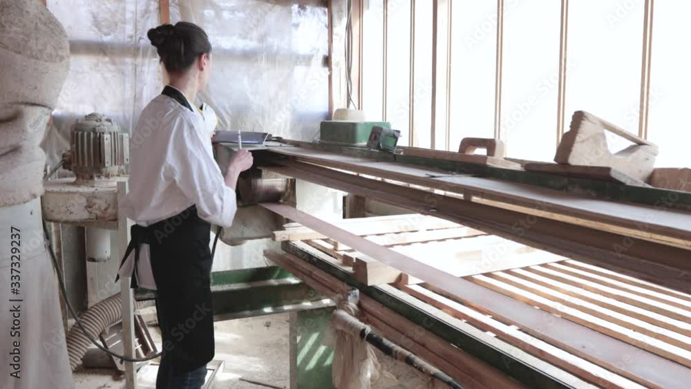 Confident woman working as carpenter in her own woodshop Confident woman working as carpenter in her own woodshop