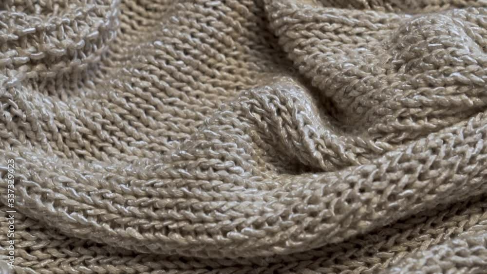 Close-up Knitted Structure of Silver-Beige Material, Fabric, Clothing, Plaid. Textile Industry Close-up Knitted Structure of Silver-Beige Material, Fabric, Clothing, Plaid. Textile Industry