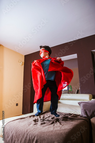 
little boy playing superheroes in quarantine time,coronavirus pandemic

 photo