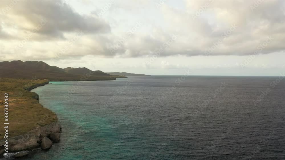 Aerial view of coast of Curacao in the Caribbean Sea with turquoise water, cliff, beach and beautiful coral reef Aerial view of coast of Curacao in the Caribbean Sea with turquoise water, cliff, beach and beautiful coral reef
