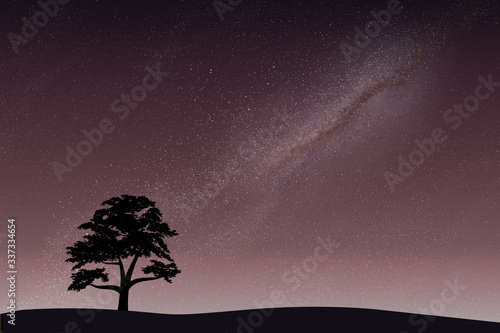 The black silhouette of a large tree on the background of the starry sky of the galaxy
